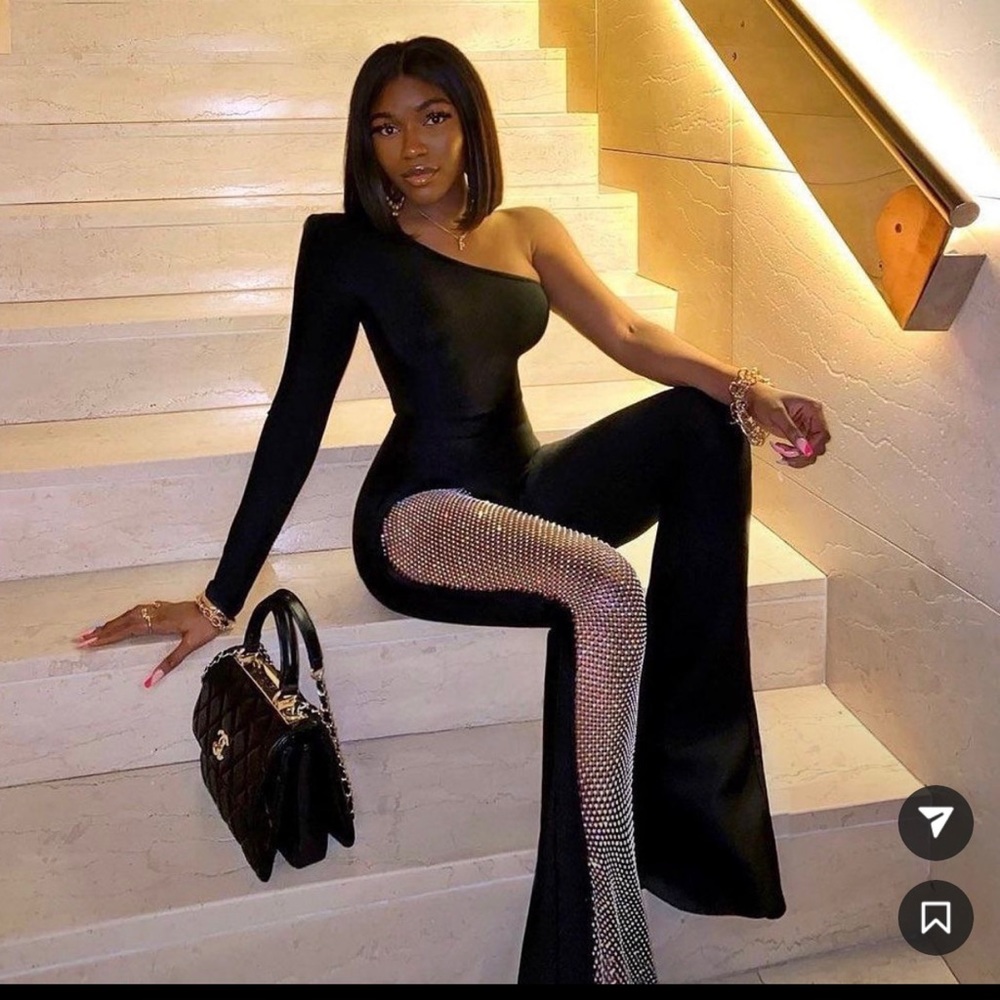 Black one shoulder jumpsuit with studded mesh leg detail.